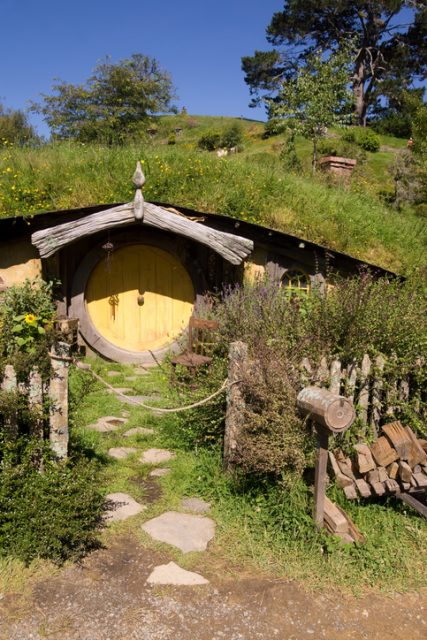 Matamata, New Zealand – 7 January 2013: A hobbit hole in The Shire at Hobbiton. Previously used in the filming of the Lord of the Rings and The Hobbit series of movies, it is part of a movie set that has been retained for guided tours. This particular hobbit hole was the residence of the character Sam.