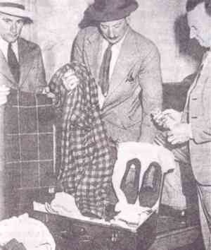 Suitcase and effects, found at Adelaide railway station. From left to right are detectives Dave Bartlett, Lionel Leane, and Len Brown
