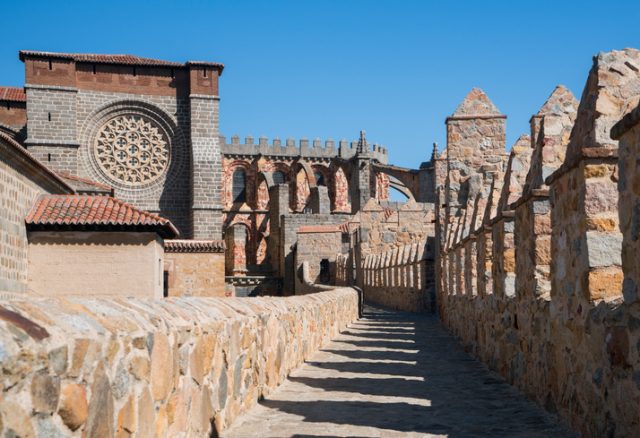 Churches and stone structures along the 12th-century city walls that surround Ávila, Spain. The walls and old city are a UNESCO World Heritage Site.