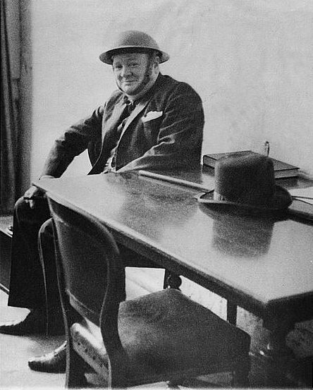 Winston Churchill wearing a helmet during an air raid in 1940