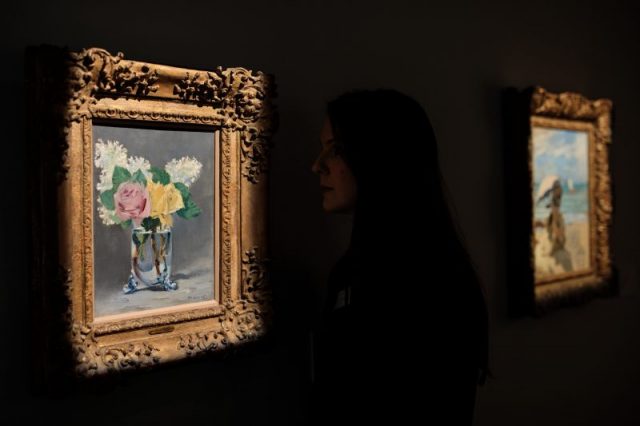 An employee poses with ‘Lilas et Roses’ 1882 by Edouard Manet (estimate $7M – 10M) during a photocall for the Peggy and David Rockefeller art collection at Christies auction house on February 20, 2018 in London, England. Christies unveiled today highlights from the Rockefeller collection ahead of the New York auction on May 7th which is expected to raise in excess of $500M, the proceeds from which are to be donated to established charities. (Photo by Jack Taylor/Getty Images)