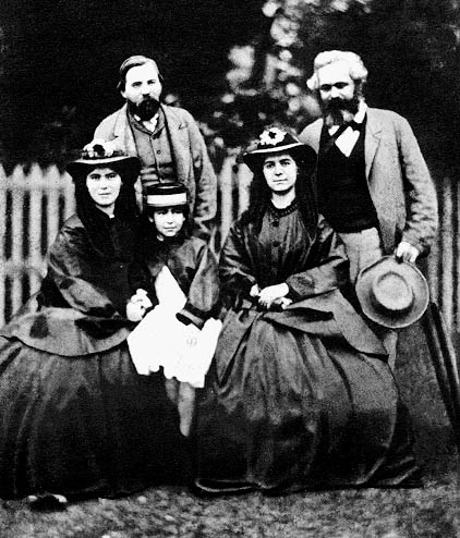 Friedrich Engels, Karl Marx and Marx’s daughters: Jenny Caroline (1844–1883), Jenny Julia Eleanor (1855–1898), and Jenny Laura (1845–1911)
