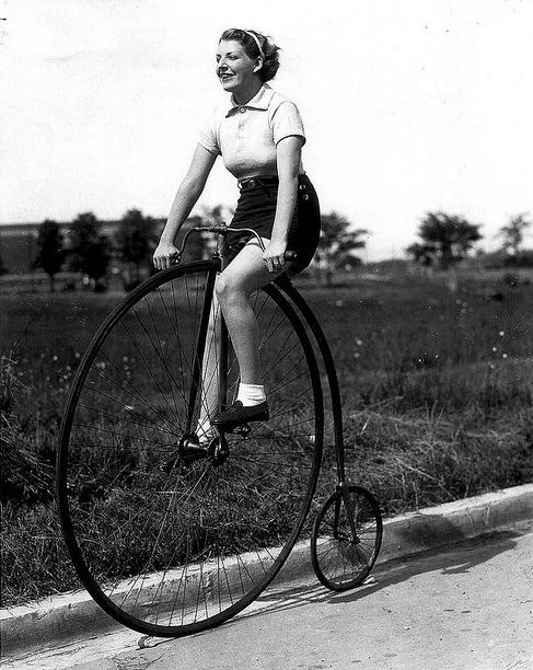 A woman riding a classic penny farthing bicycle, Toronto, 1930