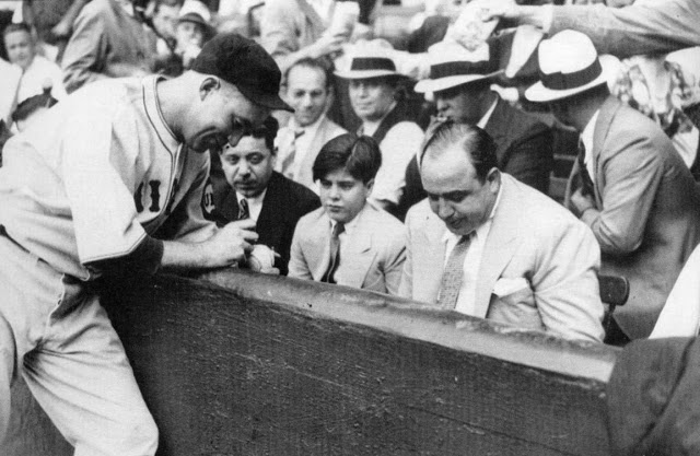 Al Capone and his son Albert Capone with a baseball signing by Chicago Cubs player Gabby Hartnett, 1931
