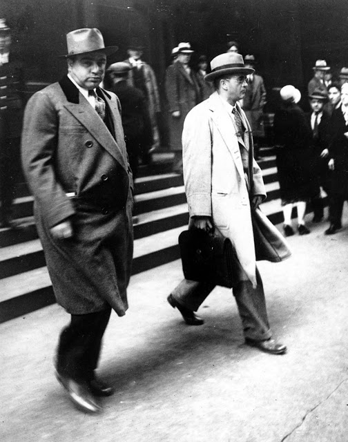 Al Capone looking straight into the camera when charging out of Federal Court in Chicago with his attorney by his side, Michael Ahern on Oct. 11, 1931