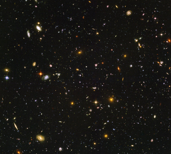 Photograph of farthest away and oldest galaxies, including one 12.8 billion light-years away from Hubble Ultra Deep Field and Spitzer Space Telescope.