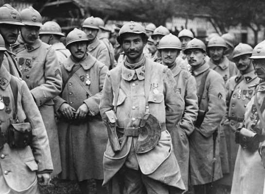 French soldiers stand in a relaxed group wearing medals. The medals appear to be the Military Medal, established on 25th March, 1916, for acts of bravery. They have probably been awarded for their part in the Battle of the Somme. The French helmets, with their very distinct crests, can be seen clearly. (National Library of Scotland)