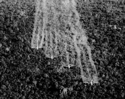 A photo provided by the U.S. Air Force shows four “Ranch Hand” C-123 aircraft spraying liquid defoliant on a suspected Viet Cong position in South Vietnam, September, 1965. source