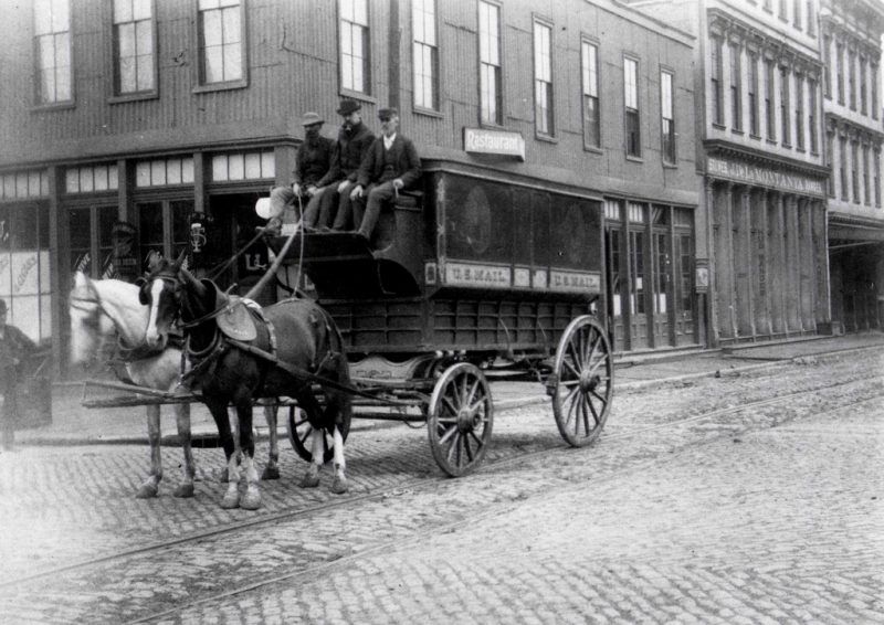 Employees driving a regulation mail wagon, size 3, on an unidentified San Francisco, California, street. 1895