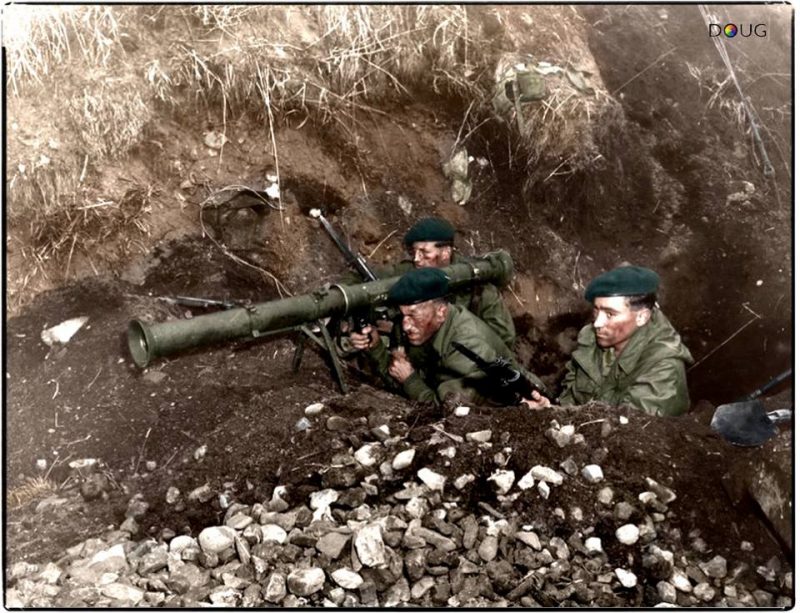 Royal Marines of 41 Commando, armed with an M20 3.5-Inch 'Bazooka' watch for enemy tanks during a seaborne raid on a North Korean rail supply route near Songjin, Korea, 6th October 1951. On 10 November 1950, 41 (Independent) Commando joined the United Nations advance in North Korea where they served with the United States Marine Corps; the second time the two organisations had served together, the first being the Boxer Rebellion. During the Battle of Chosin Reservoir Lt. Col. Drysdale was given command of a 900 man unit of his own Commando, American, and South Korean forces called Task Force Drysdale.  Their hard fighting together with the American Marines and Army led to 41 Independent Commando being awarded the American Presidential Unit Citation that the 1st Marine Division earned.  The Commando reformed in Japan and in April 1951 were assigned to what eventually became the 1st Commonwealth Division. They raided the North Korean coast with the Republic of Korea Marine Corps until 41 Commando returned to England in December 1951. (Colourised by Doug) https://www.facebook.com/ColouriseHistory?fref=nf