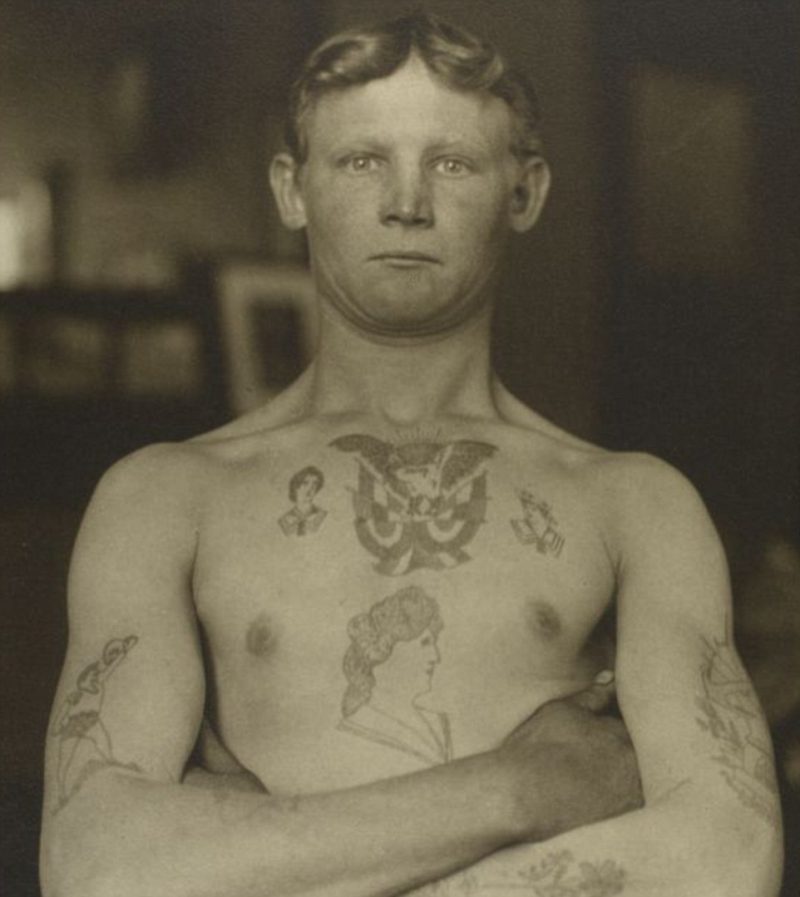 One man, covered in tattoos, is simply referred to as a German stowaway by the amateur photographer and register clerk 
