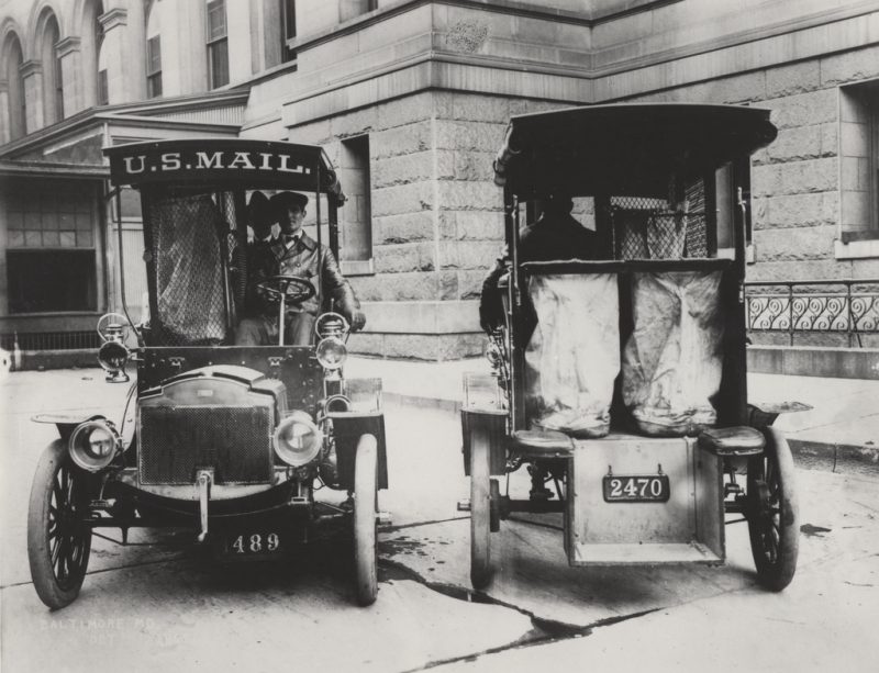 Two Columbia Mark mail trucks face in opposite directions.