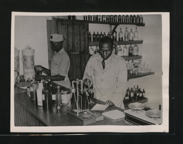  A Kikuyu assistant makes up a prescription in the dispensary. (Picture issued 1945)