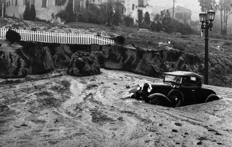 March 2, 1938 A mudslide at Harper Avenue and Sunset Boulevard caught this automobile and closed the area to traffic.