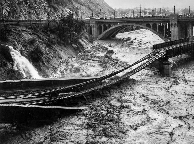 March 2, 1938 Floodwaters in Los Angeles River destroy Southern Pacific railroad bridge. The photo was taken from North Figueroa Street bridge.
