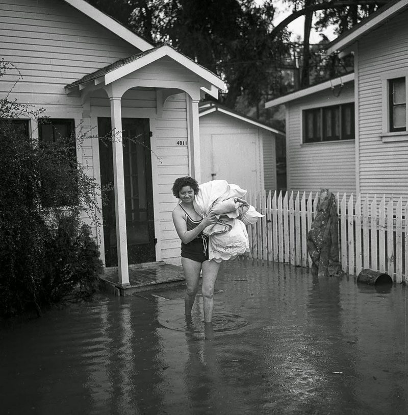 March 2, 1938 Mrs. L. Swink put on her swimsuit as she moved out after flooding.