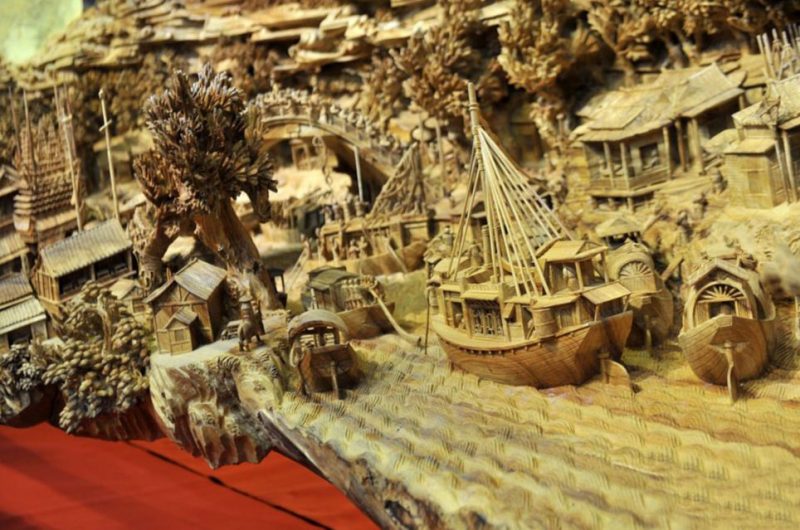 A giant masterpiece has been recorded as the longest one piece wood carving in the world. And the time it took to get it officially recognised is also almost a record - after the exhibition hall where it is housed revealed it was actually crafted in Fujian province in southeast China nearly 1,000 years ago. Called "Riverside Scene at Qingming Festival", it has only now been recognised by the Guinness Book of World Records as the largest single piece wood carving in the world. The work measure 12.286 meters long, and at the highest point is 3.075 meters. It is also 2.401 meters wide. It took artist Zheng Chunhui four years to complete and currently is stored at the Palace Museum in Beijing where it is recognised as a national treasure. A museum spokesman said: "He was a master craftsman but sadly this is the only piece of his work to have survived. But nevertheless it is a remarkable piece. "It gives a 3D snapshot of a period in the life of daily life of people of all ranks in the capital city of Bianjing (today's Kaifeng, Henan Province) during Qingming Festival in the Northern Song Dynasty. As such it is also a valuable historical witness, bringing the period to life in a way that a book or scroll never could. "It's the next best thing to experiencing it in real life, showing rich and poor about their daily business. In fact there are 550 people in the carving."
