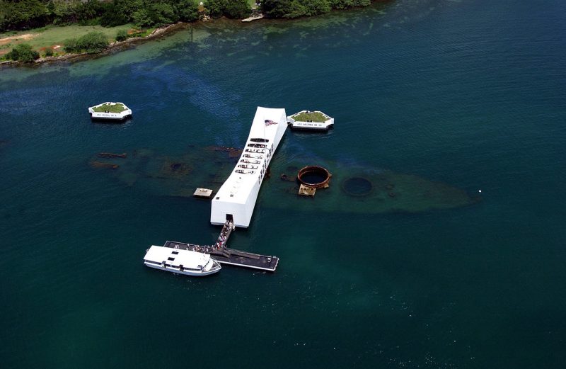 Aerial view of the USS Arizona Memorial, showing the wreck and oil seepage from the ship's bunkers