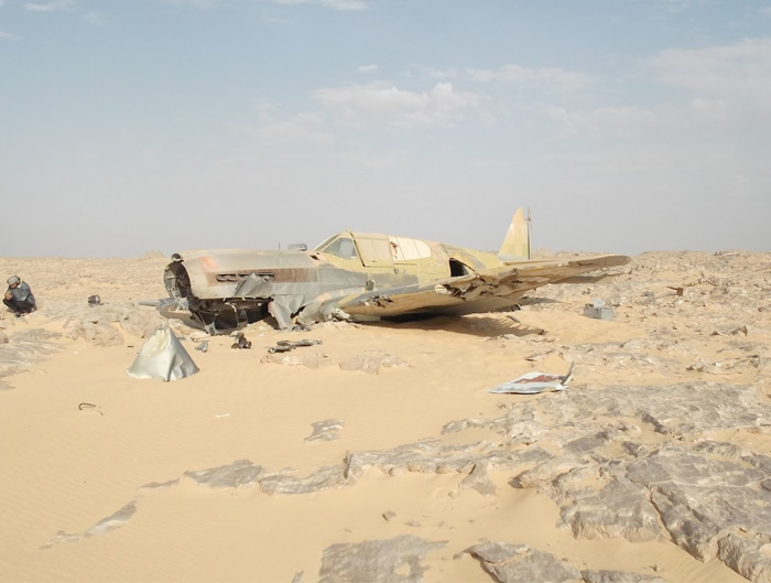Here we see the power of the sun as it beats relentlessly down on the P-40 in the Egyptian desert. Most of the front of the fuselage and wings has been scoured of paint by the sand perhaps indicating that the aircraft was pointed into the prevailing winds - logical as the pilot would have landing up wind. Photo: Jakub Perka
