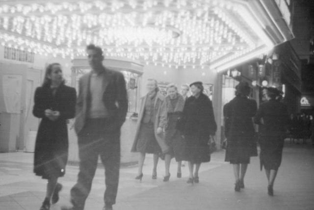 People walk under the marquee of the Hollywood Theater sometime in the 1930s