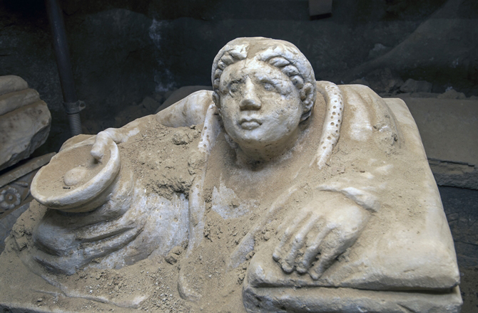 figure on the lid of one of the urns containing the ashes of the deceased.