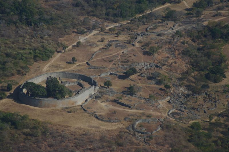 Aerial view of Great Zimbabwe’s Great Enclosure (circumference 250 m, maximum height 11 m) and adjacent ruins looking southeast from the Hill Fort. source