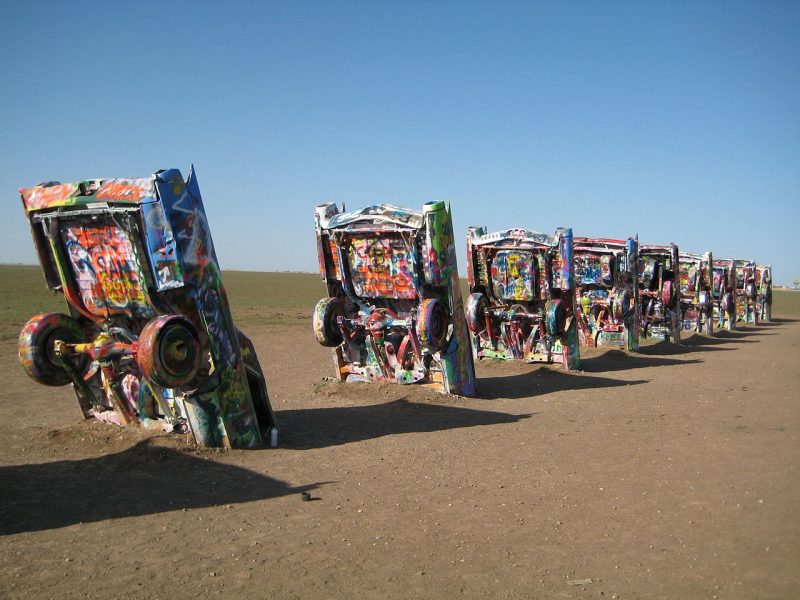 Brightly painted Cadillacs, all in a row. Richie Diesterheft/WikimediaCommons