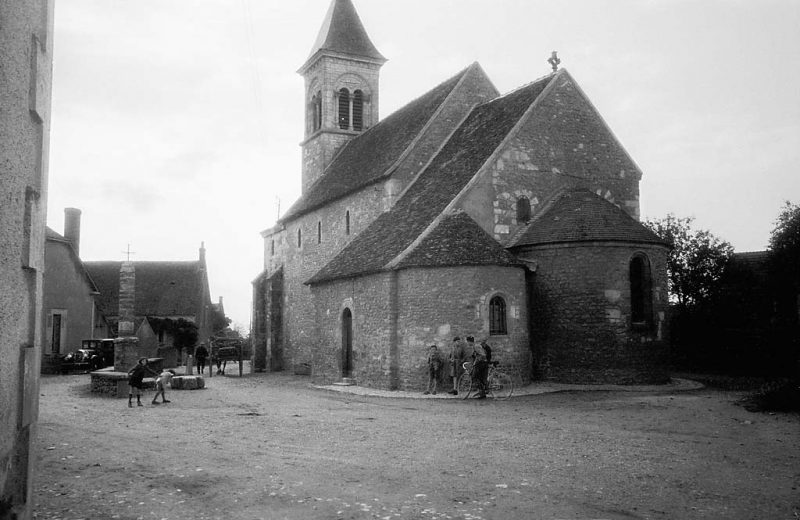 Children outside the Romanesque church of Saint-Martin de Nohant-Vic in Indre