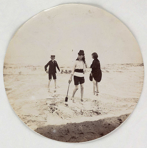 Children paddling in the sea, about 1890