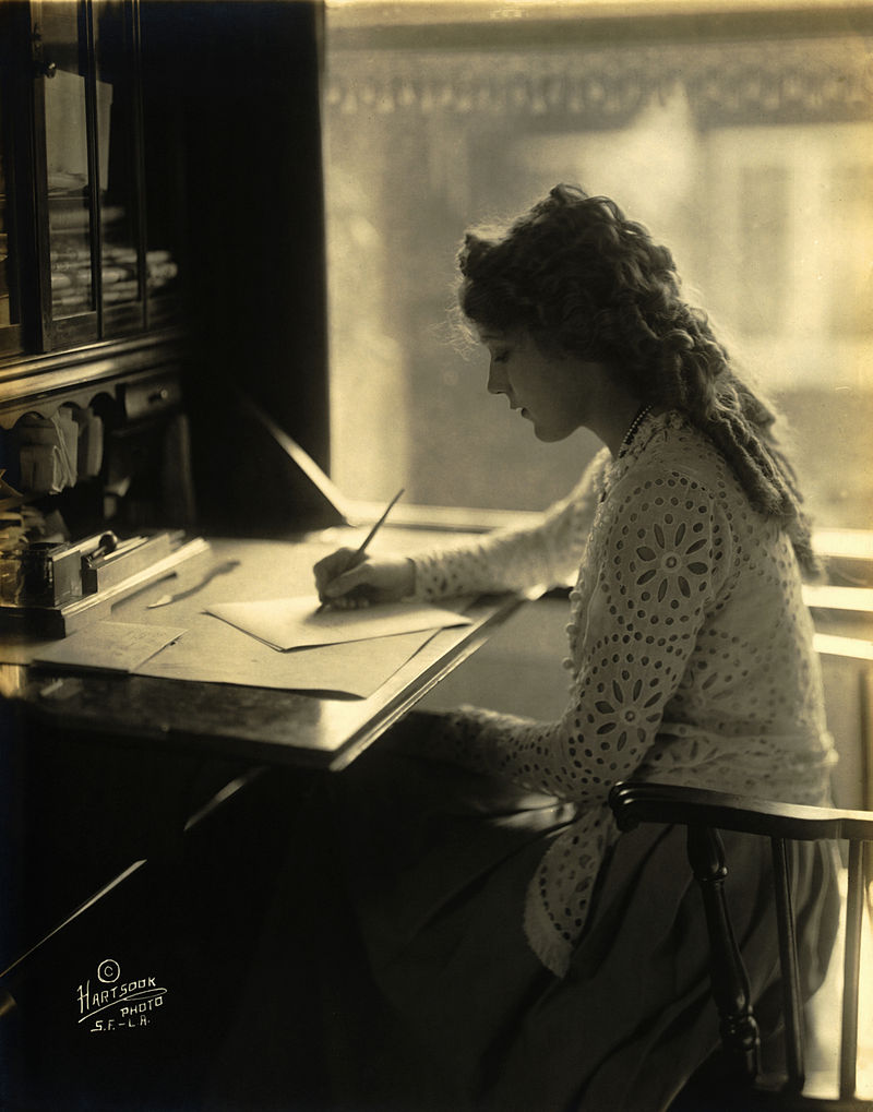 Mary Pickford writing at a desk. .Source