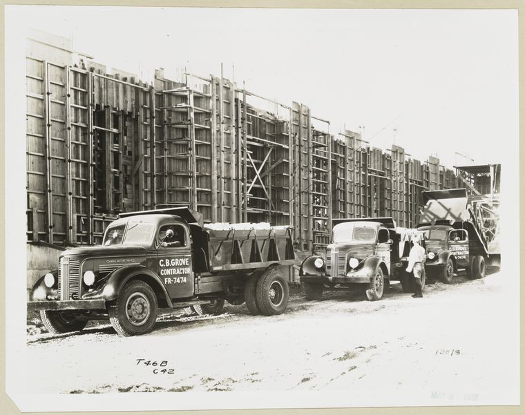 Model T 46 B C 42 loading building materials at a construction site.