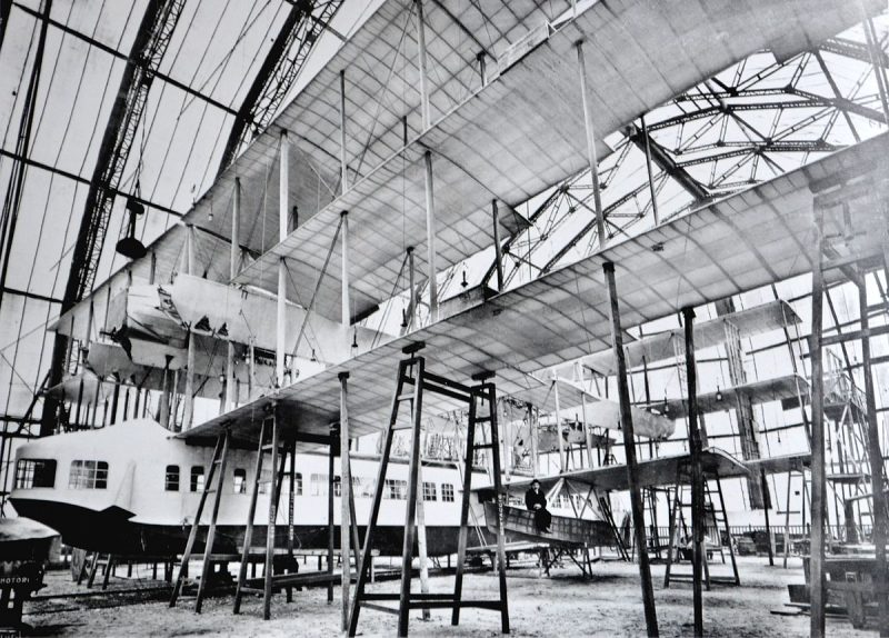 The Transaereo under construction in Sesto Calende. Gianni Caproni is sitting on the left side outrigger. source