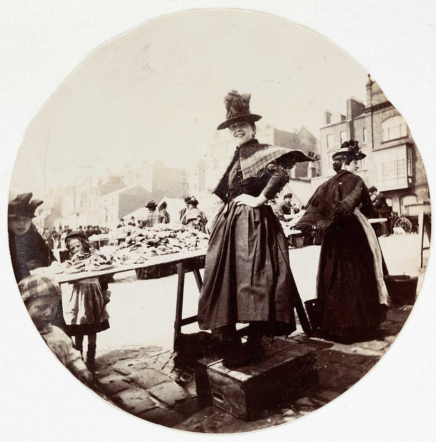 Woman at a market stall, about 1890