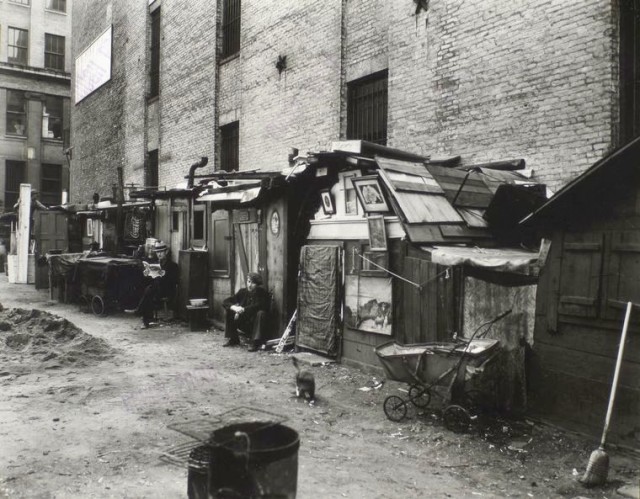 Huts and unemployed in West Houston and Mercer St by Berenice Abbott in Manhattan in 1935
