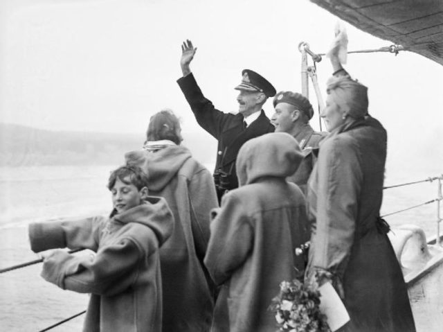 The Royal Family of Norway waving to the welcoming crowds from HMS Norfolk at Oslo.