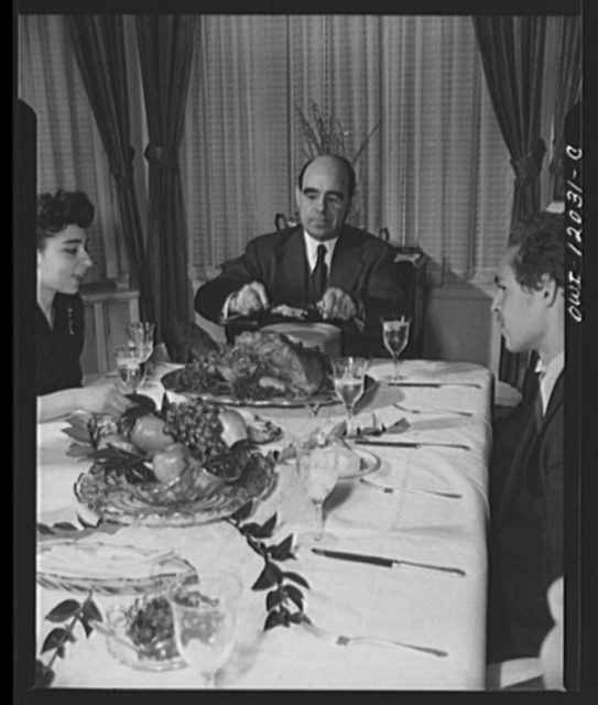 Dr. Mordecai Johnson, president of Howard University, serving portions of Thanksgiving turkey to members of his family in 1942.
