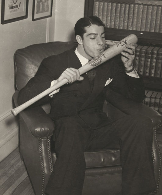 DiMaggio kisses his bat in 1941, the year he hit safely in 56 consecutive games.