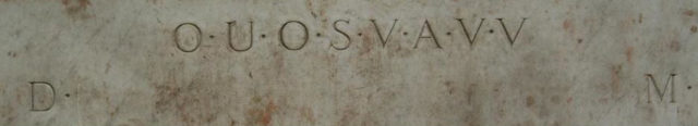 Still a mystery: the eight letters ‘OUOSVAVV’, framed by the letters ‘DM’