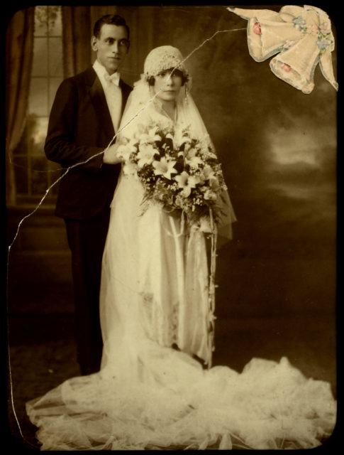 The bride wears a cloche hat styled headpiece.