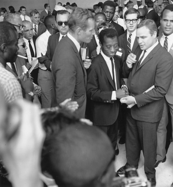 Author James Baldwin with actors Marlon Brando and Charlton Heston at the Civil Rights March on Washington in 1963.