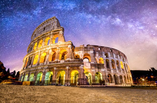 Front view of Colosseum of Rome at night with the milky way above. Italy.