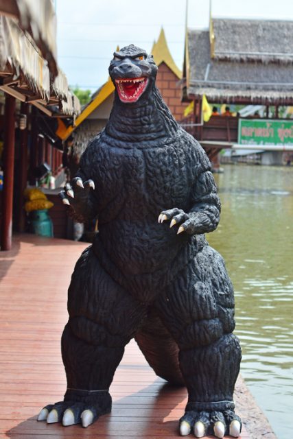 Godzilla model stand outdoor at Thung Bua Chom floating market