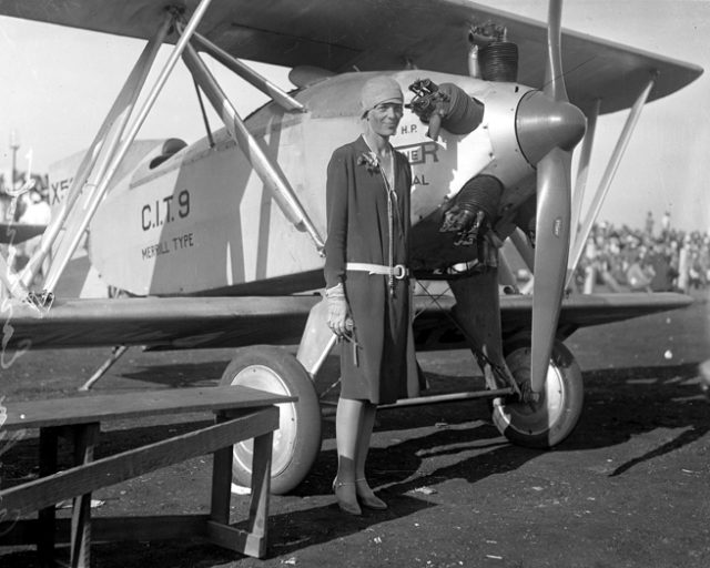 Amelia Earhart standing beside a Merrill CIT-9 Safety Plane, Los Angeles, c.1928.
