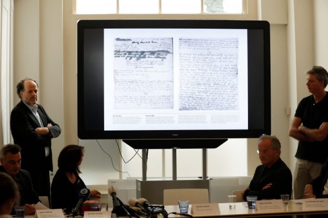 Ronald Leopold (L), executive director of the Anne Frank House, presents two unknown pages of Anne Frank’s diary, during a press conference on May 15, 2018 in Amsterdam. – Two pages of Anne Frank’s world-famous diary – which she covered over with brown paper, discovering dirty jokes and a teenager’s interest in sex – have been made visible with digital photo-editing techniques. (Photo by Bas CZERWINSKI / ANP / AFP Getty Images)
