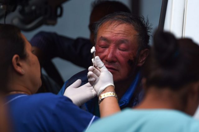 In this picture taken on May 16, 2018, Chinese double amputee climber Xia Boyu, who lost both of his legs during first attempt to climb Everest, receives medical attention in an ambulance at an hospital, after returning from a successful summit of Mount Everest in Kathmandu (Photo by PRAKASH MATHEMA / AFP/Getty Images)