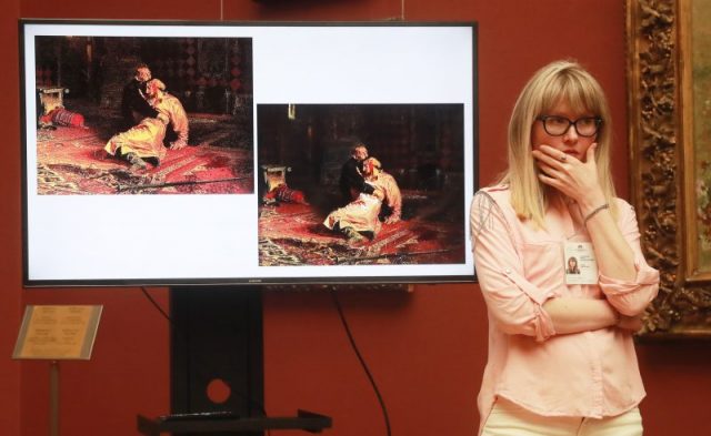 A screen shows Ilya Repin’s painting Ivan the Terrible and His Son Ivan, damaged by 37-year-old Igor Podporin of the city of Voronezh on May 25, 2018, during a briefing by the State Tretyakov Gallery; the painting was taken to the restoration. Sergei Fadeichev/TASS (Photo by Sergei Fadeichev\TASS via Getty Images)