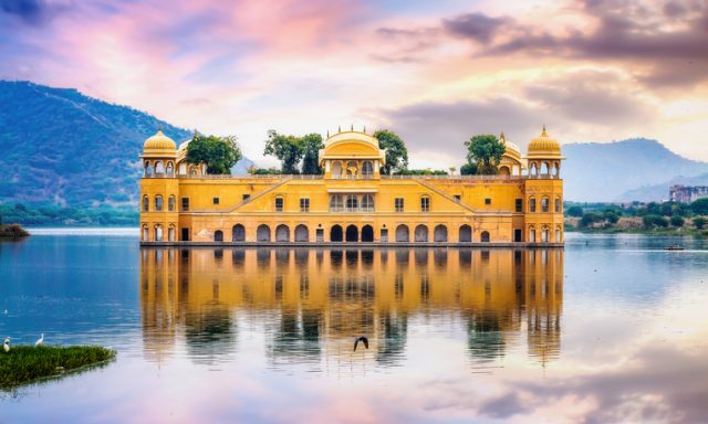 Jal Mahal water palace Jaipur Rajasthan at sunset with vibrant moody sky
