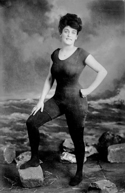 Annette Kellerman (1887-1975), Australian professional swimmer, vaudeville and film star in her famous custom swimsuit (designed to allow for serious athletic swimming, unlike conventional women’s swimwear of the period, but considered indecent by some). 1900.