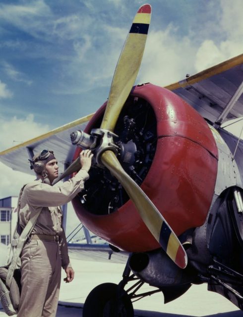 Aviation Cadet Thanas probes the engine of an airplane.