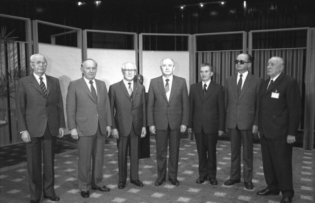 Warsaw Pact leaders, 1987 (from left): Husák of Czechoslovakia, Zhivkov of Bulgaria, Honecker of East Germany, Gorbachev of the Soviet Union, Ceaușescu, Jaruzelski of Poland, and Kádár of Hungary. Photo by Bundesarchiv, Bild 183-1987-0529-029 / CC-BY-SA 3.0